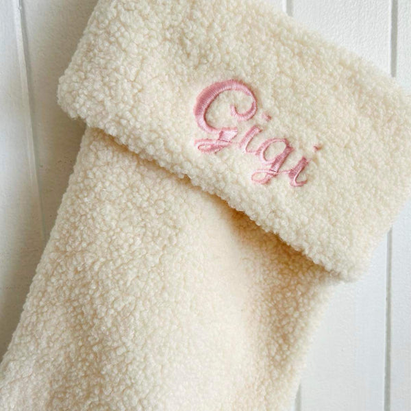 Beautiful pink embroidery on a plush Christmas stocking with the name Gigi by Curious Grace Co.