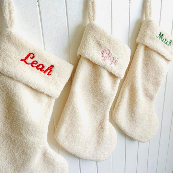 Personalised Christmas Stocking with stunning red, green and pink embroidery on a boucle Christmas stocking by Curious Grace Co.